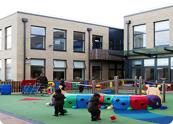 Colindale Primary School playground with children playing on a colourful climbing frame