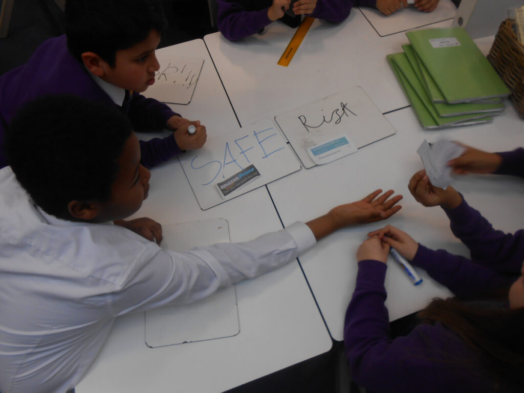 Pupils sorting cards into safe and risk during a PSHE lesson