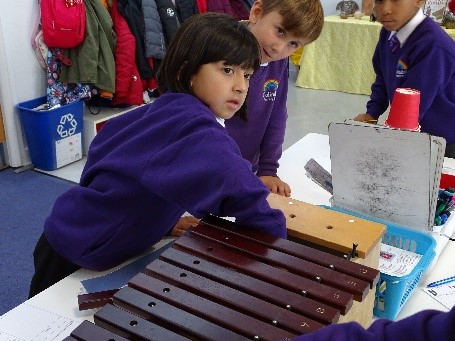 Pupils exploring sound with a xylophone